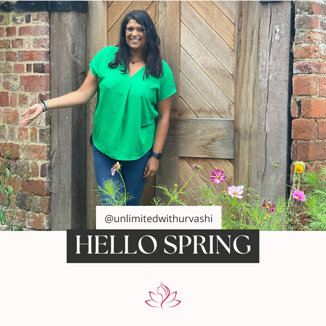 Urvashi outside in a garden on summers day laughing 